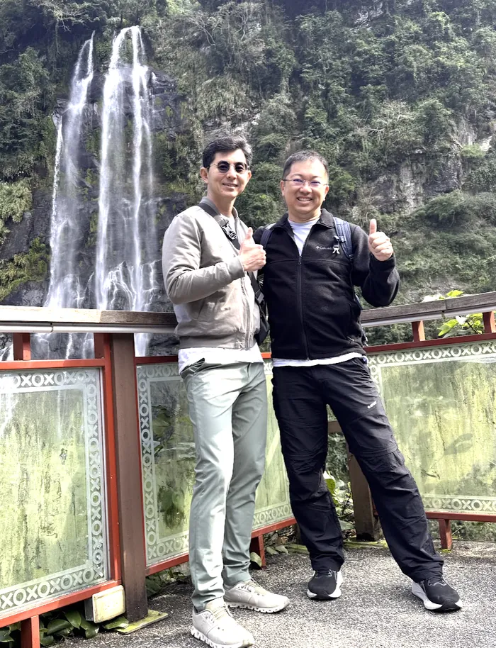KC Lau and John Huo at a waterfall in Taiwan